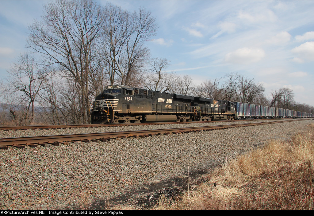 NS 7704 leads trash train 63V west